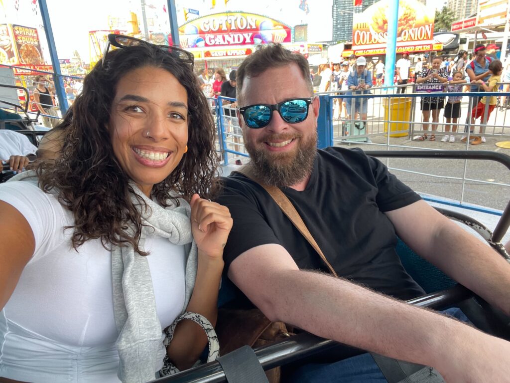 two people smiling into camera on ride